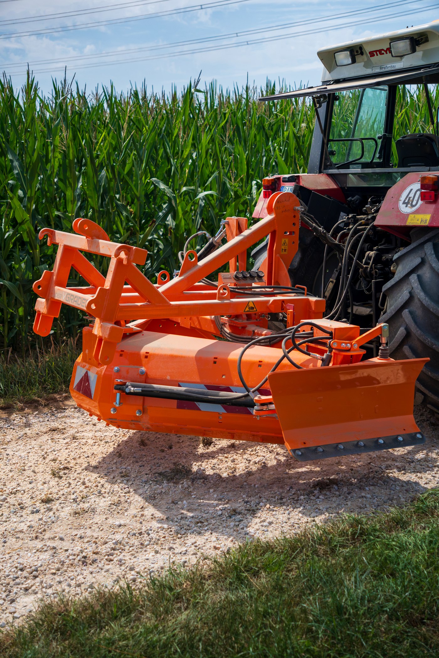 VGrader 205K mounted on a tractor, working on a field track